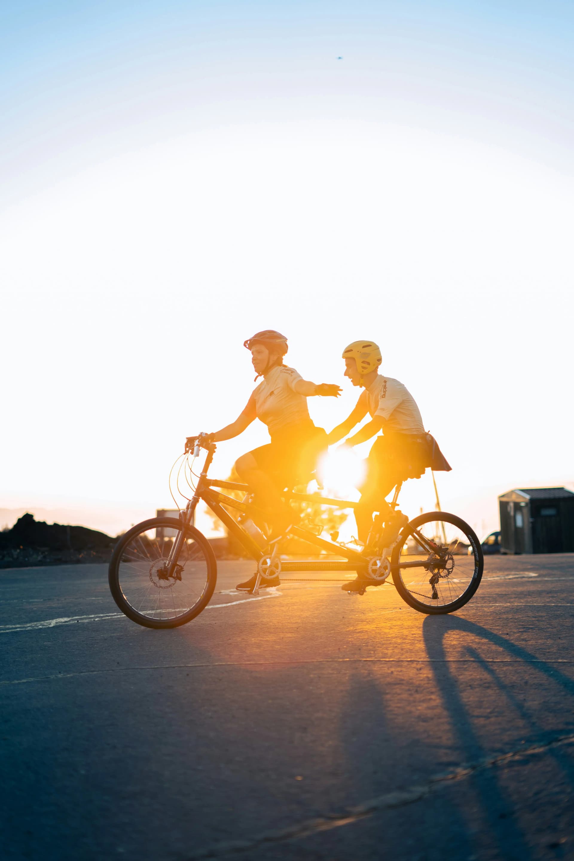 Couple sharing a bike ride at sunset
