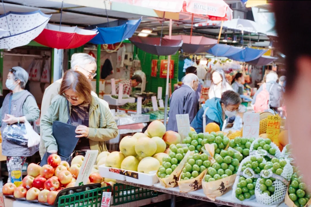Colorful outdoor market with fresh fruit and produce stalls