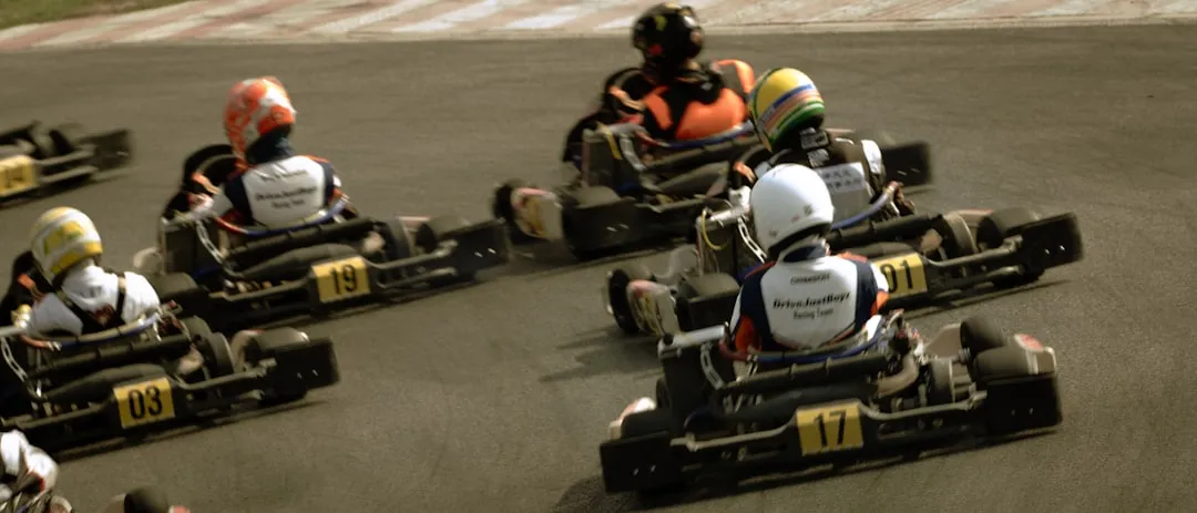 Group of people racing go-karts on track