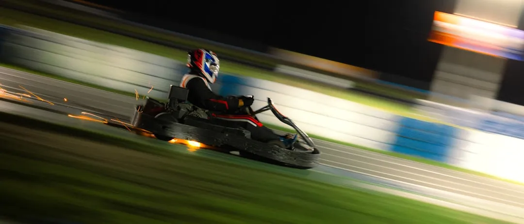 Go-kart racing around track at night