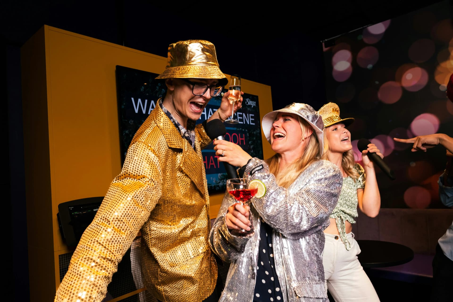 People singing karaoke and having fun at a karaoke night