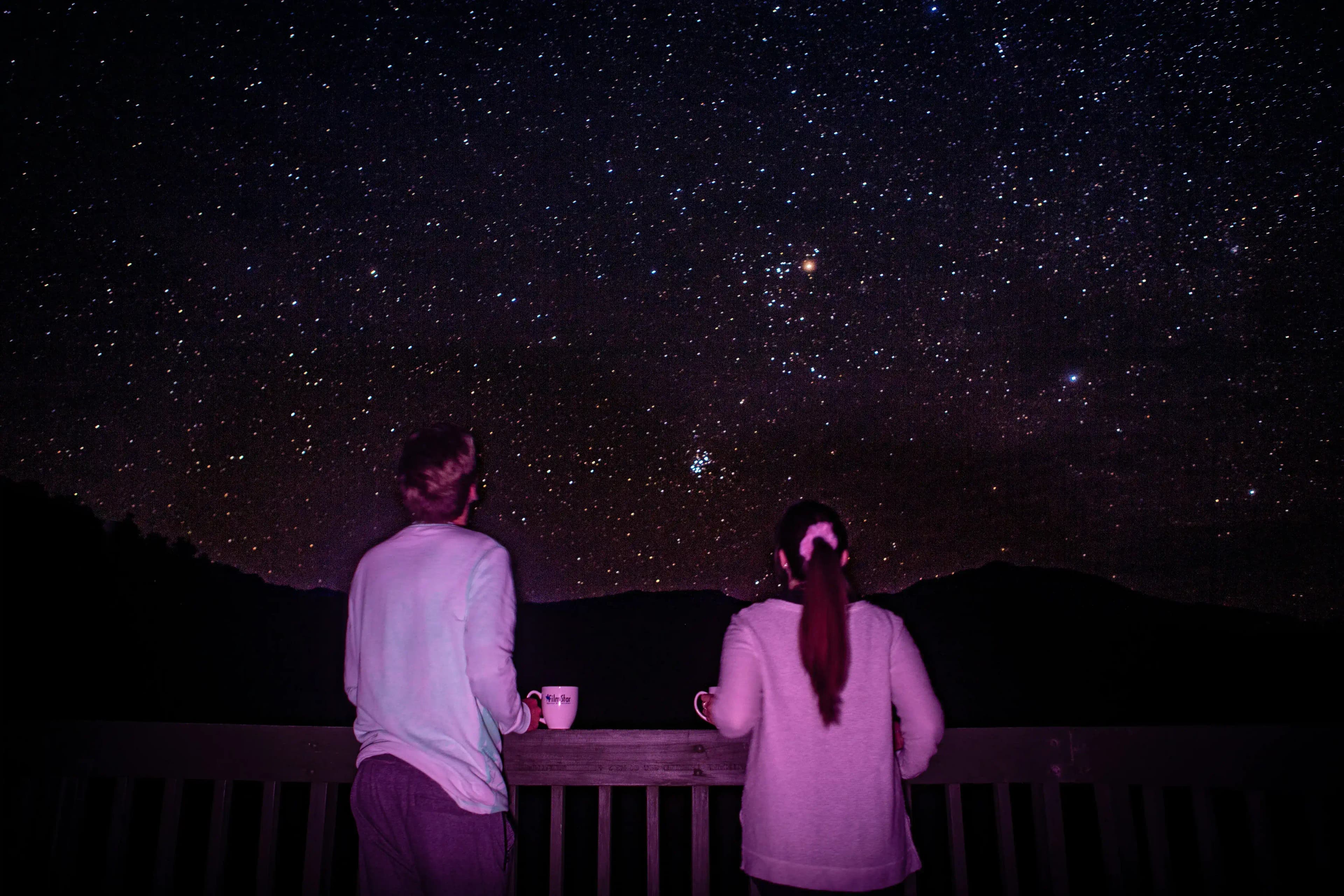 Couple standing together looking at the stars