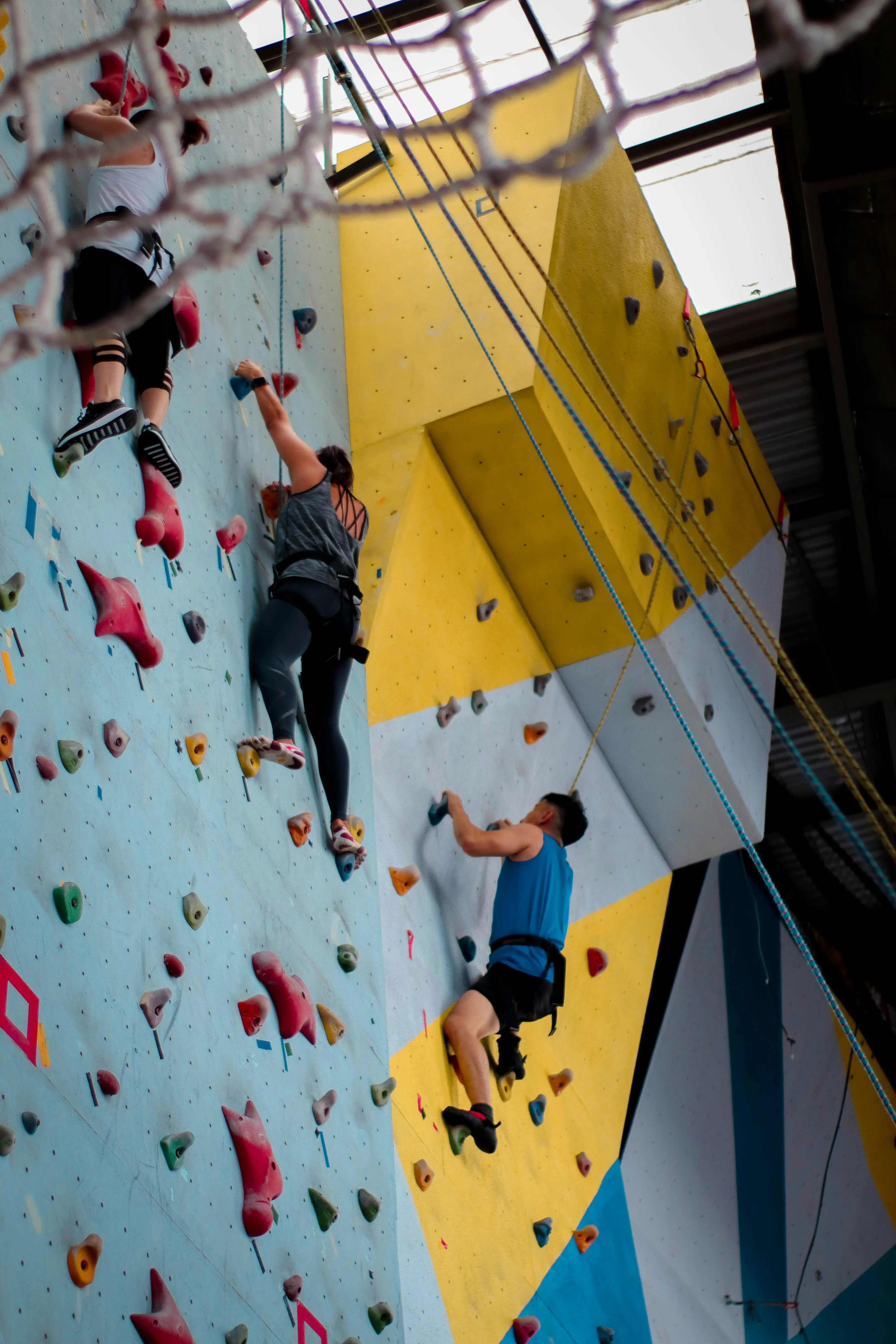 People enjoying indoor rock climbing together