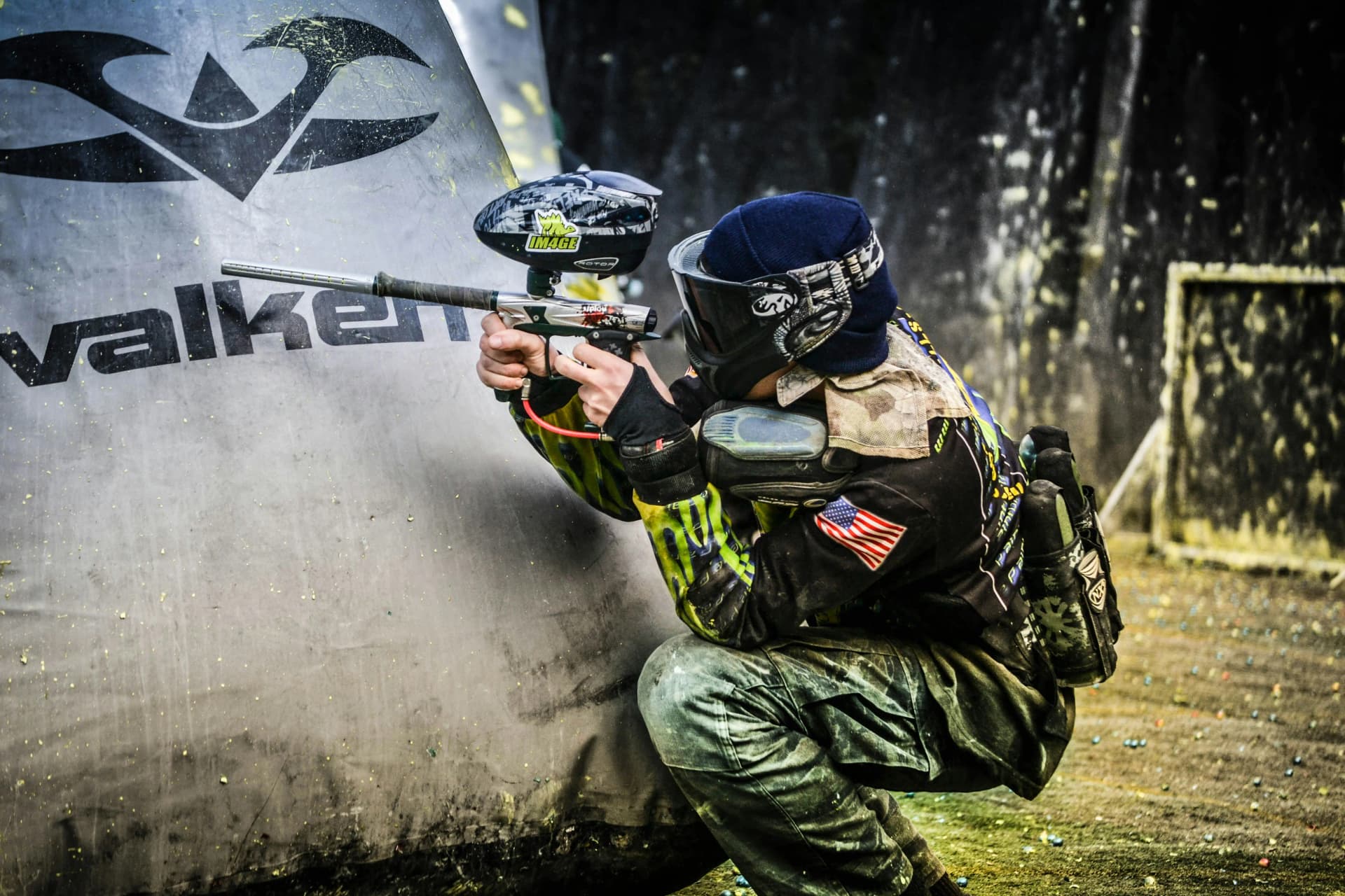 Person playing paintball in outdoor field